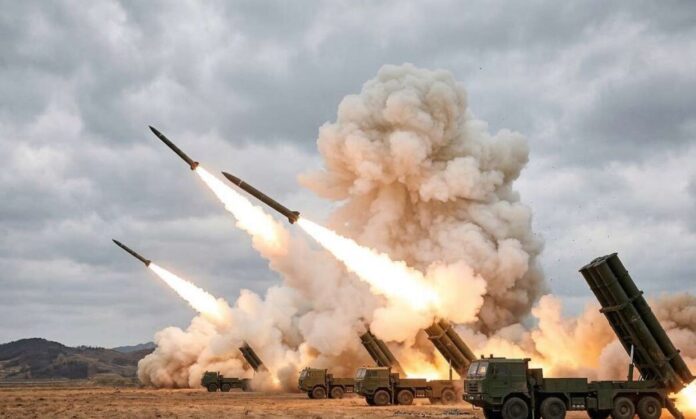 Multiple green military truck-mounted rocket launchers firing missiles simultaneously with flames and smoke against a cloudy sky.