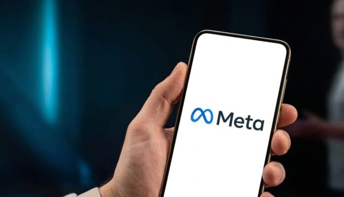 Smartphone displaying the blue Meta logo held in hand, representing Meta Platforms' workforce